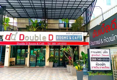 a building with many signs in front of it at Double D Rooms & Cafe in Bangkok