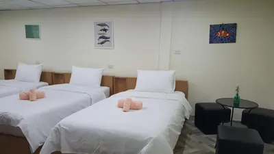 a room with three beds with pink pillows on them at Double D Rooms & Cafe in Bangkok