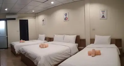 a room with three beds with teddy bears on them at Double D Rooms & Cafe in Bangkok