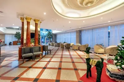 a lobby with a christmas tree and chairs at Royal Benja Hotel - Big Rooms, Family Friendly in Bangkok