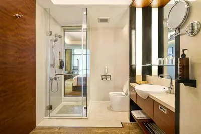 a bathroom with a shower and a toilet and a sink at AETAS lumpini in Bangkok
