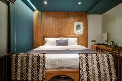 a bedroom with a large bed with a blue wall at Sib Kao in Bangkok