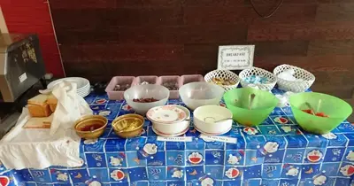 a table with bowls and plates on top of it at Khurana Inn in Bangkok