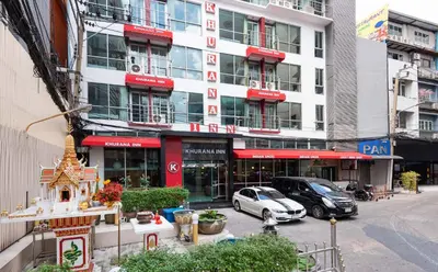 a building with cars parked in front of it at Khurana Inn in Bangkok