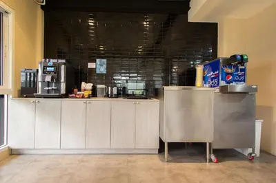 a kitchen with a counter with a coffeeasteryasteryasteryasteryasteryasteryasteryastery at Lazy Sunday hostel in Bangkok