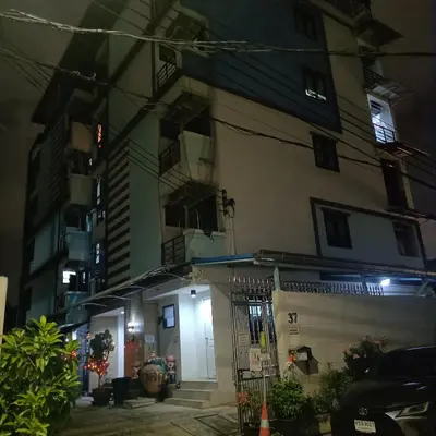 an apartment building at night with a building at PA House Apartment in Bangkok
