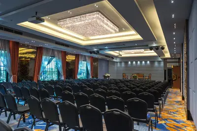 a conference room with a row of chairs and a stage at Nouvo City Hotel in Bangkok