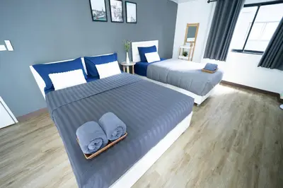 a bedroom with two beds with towels on them at Baansuay Rattanathibet Apartment in Nonthaburi