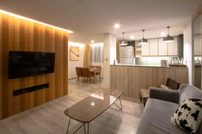 a living room with a couch and a table at The Residence Rajtaevee Hotel in Bangkok