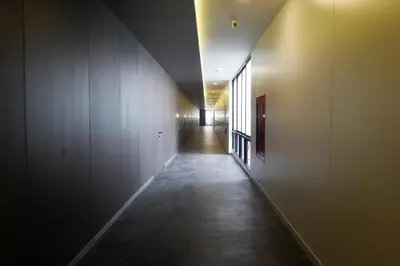 a hallway with a long corridor in a building at Reno hotel in Bangkok