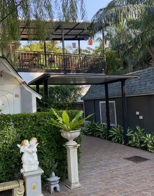 a house with a walkway and a balcony with a bridge at Kurina Hotel in Bangkok