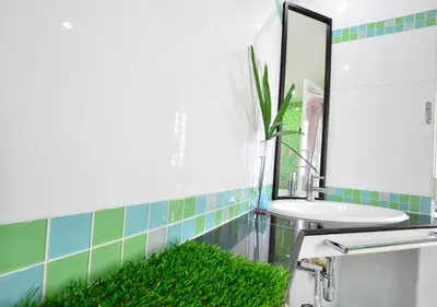 a bathroom with a sink and a mirror at Ayi Home in Bangkok