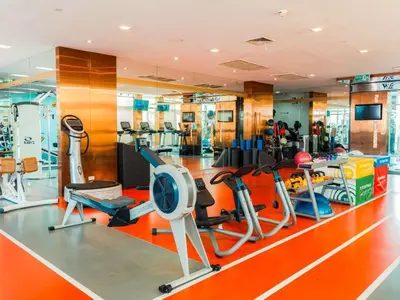 a gym with several treadmills and exercise equipment at VIE Hotel Bangkok - MGallery Collection in Bangkok