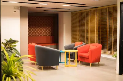 a waiting room with chairs and a table at Live at Home Sukhumvit 105 in Bangkok