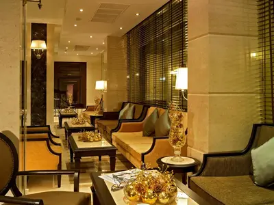 a hotel lobby with couches and tables and chairs at Gulliver's Tavern Hotel in Bangkok