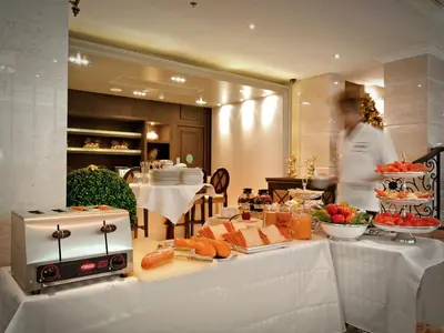 a man standing in front of a table with food at Gulliver's Tavern Hotel in Bangkok