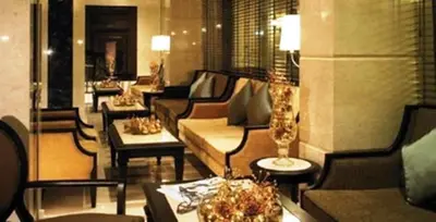 a lobby with couches and tables in a building at Gulliver's Tavern Hotel in Bangkok