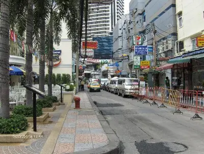 a busy city street with cars parked on the road at Dazzle Residence in Bangkok