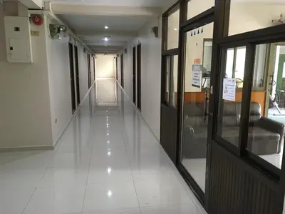 an empty hallway in a hospital with a hallwaygue at Chanmuan Resident in Bangkok