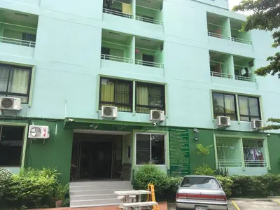 a building with a car parked in front of it at Chanmuan Resident in Bangkok