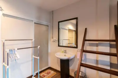 a bathroom with a sink and a mirror at Phobphan Hostel in Bangkok