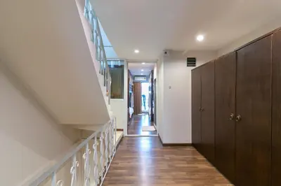 a hallway of a house with a staircase and a stair case at Phobphan Hostel in Bangkok
