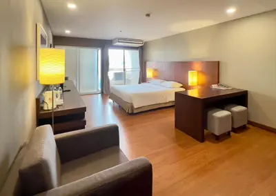 a hotel room with a bed and a couch at BU Place Hotel in Bangkok