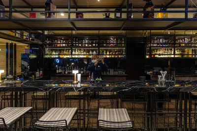 a person taking a picture of a bar at Jasmine Resort Bangkok in Bangkok