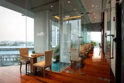 a restaurant with tables and chairs in a building at Jasmine Resort Bangkok in Bangkok