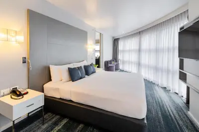 a bedroom with a large white bed and a window at Best Western Sukhumvit 20 in Bangkok