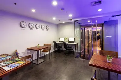 a room with tables and chairs and clocks on the wall at Best Western Sukhumvit 20 in Bangkok