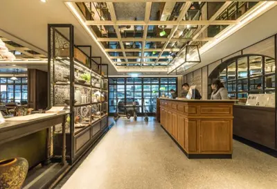 a restaurant with two people sitting at a counter at Tastoria Collection Sukhumvit in Bangkok