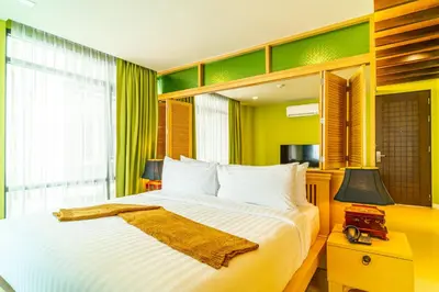 a bedroom with a large bed and a window at Amber Boutique Silom in Bangkok