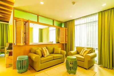 a living room with a couch and a chair at Amber Boutique Silom in Bangkok