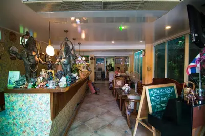 a restaurant with a counter with figurines on it at Samsen Sam Place in Bangkok