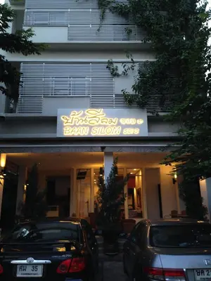 two cars parked in front of a building at Baansilom Soi 3 in Bangkok