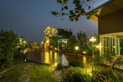 a lit up courtyard at night with a building at Beyond Suite in Bangkok