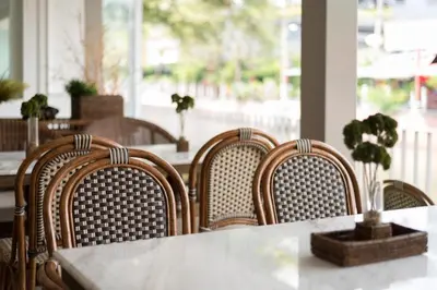 a group of chairs at a table in a restaurant at Casa Vimaya Riverside in Bangkok