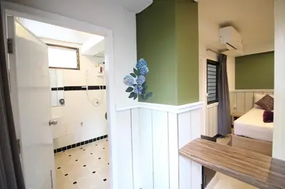 a bathroom with a bedroom with a bed and a shower at Kaya Place in Bangkok