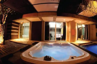 a large jacuzzi tub in a room with at Eurna Resort Hotel in Bangkok