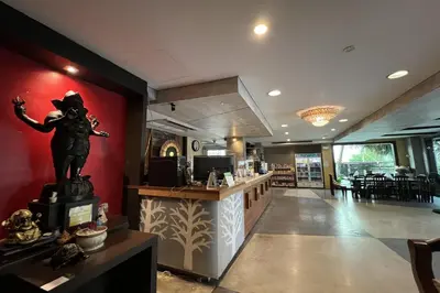 a restaurant with a statue of a cowboy on the wall at Eurna Resort Hotel in Bangkok