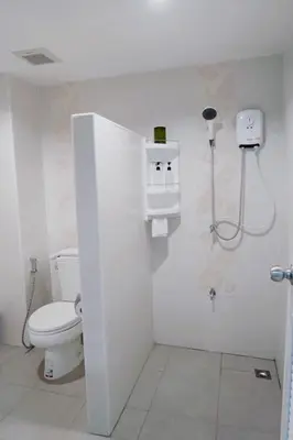 a white bathroom with a toilet and a sink at S44ROOM in Bangkok