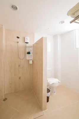 a bathroom with a shower and a toilet at S44ROOM in Bangkok