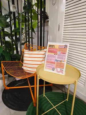 a table and a chair with a sign on it at 101 SEOUL HOSTEL (101 โซล โฮสเทล) in Bangkok