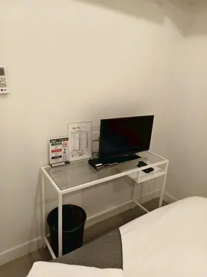 a desk with a computer on top of it at 101 SEOUL HOSTEL (101 โซล โฮสเทล) in Bangkok