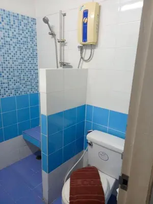 a blue and white bathroom with a toilet and a shower at Mansion Sarasinee @ Chatuchak in Bangkok