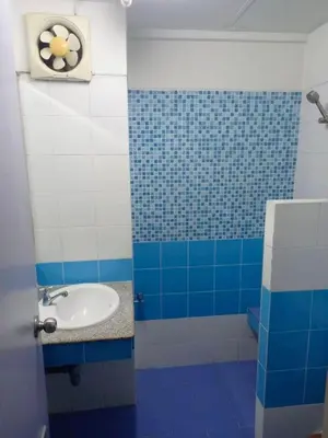 a bathroom with a sink and blue and white tiles at Mansion Sarasinee @ Chatuchak in Bangkok