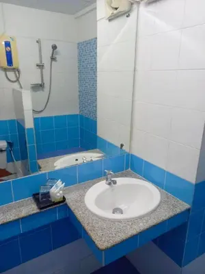 a blue and white bathroom with a sink and a shower at Mansion Sarasinee @ Chatuchak in Bangkok
