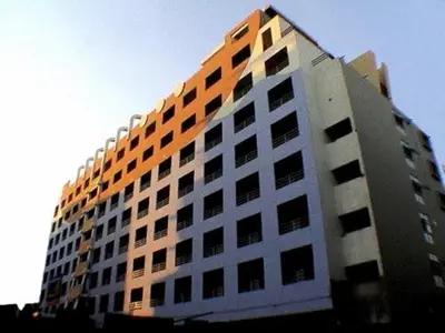 a tall building with an orange and white at Mansion Sarasinee @ Chatuchak in Bangkok