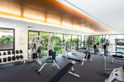 a gym with treadmills and exercise equipment at Amanta Hotel & Residence Ratchada in Bangkok
